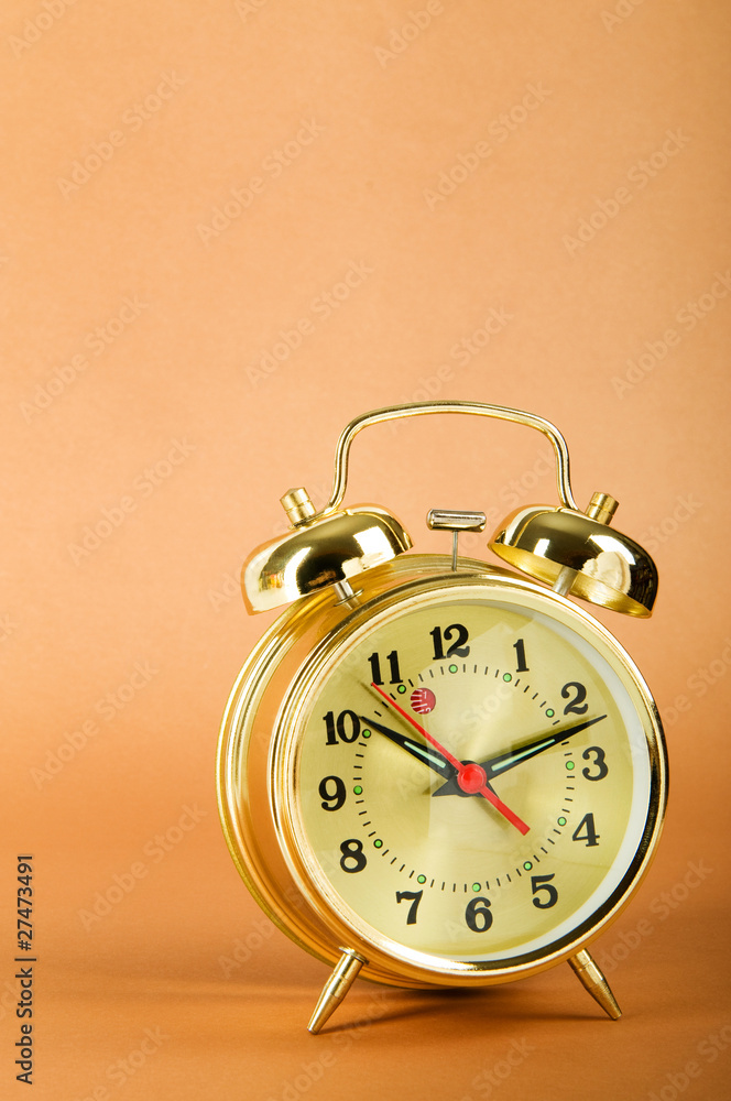Time concept - alarm clock against colorful background Time concept - alarm clock against colorful background