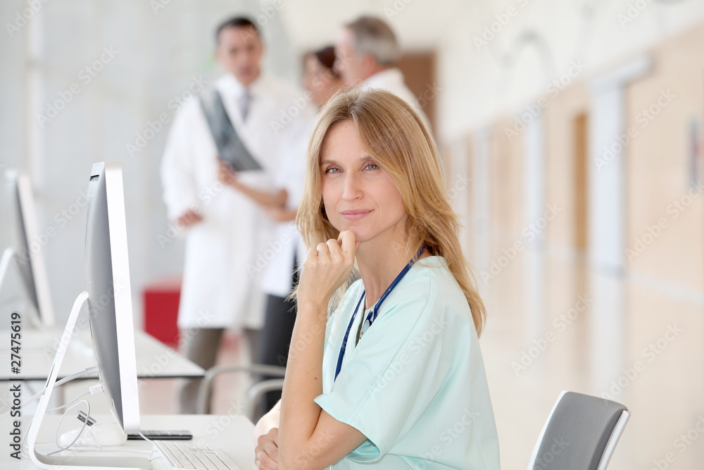 Portrait of beautiful nurse in front of medical people Portrait of beautiful nurse in front of medical people