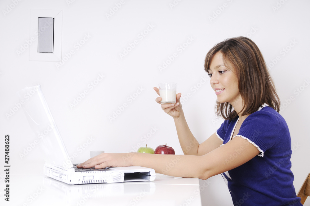breakfast of woman with milk and looking laptop