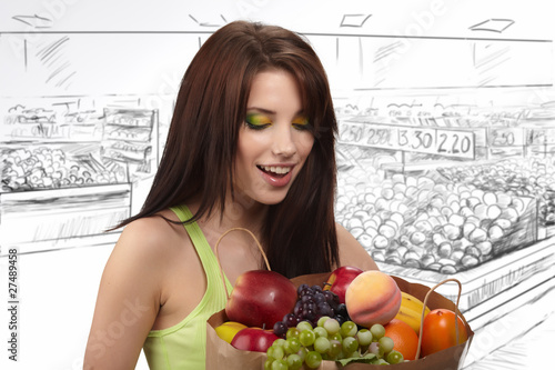 woman in a supermarket at the vegetable shelf shopping for groce photo