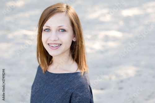 Beautiful girl wearing braces and smiling charmingly