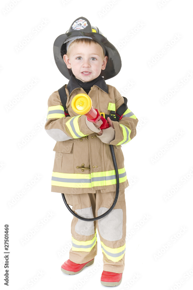 Toddler dressed as fireman ready to put out a fire Toddler dressed as fireman ready to put out a fire