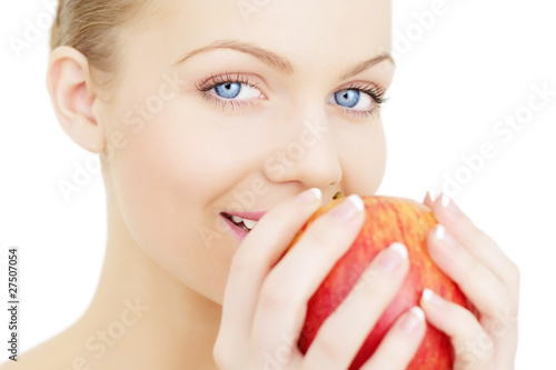 Beautiful girl holding a red apple isolated on white background