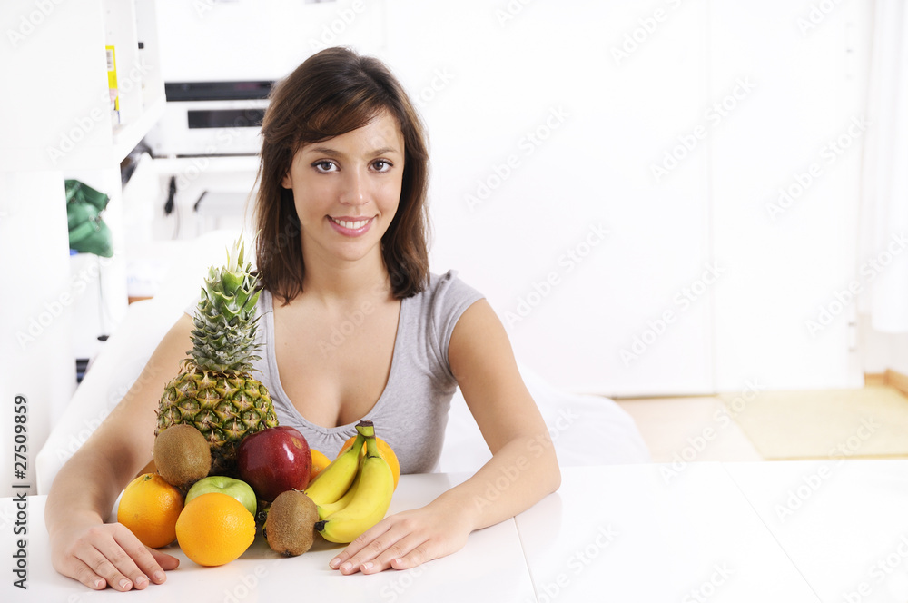 young woman with fruit, smiling and looking in camera young woman with fruit, smiling and looking in camera