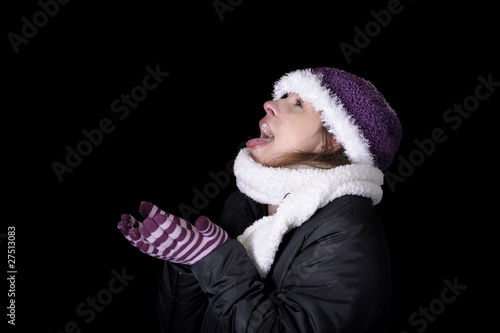 snowing on young woman in winter clothes