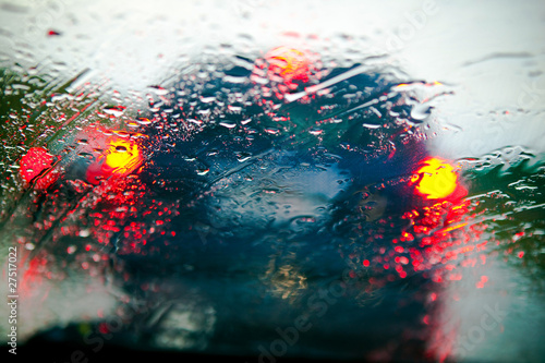 Car windshield in traffic jam during rain