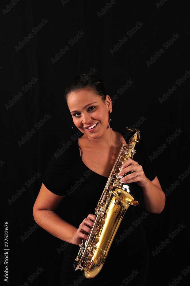 Fototapeta premium Young woman with saxophone
