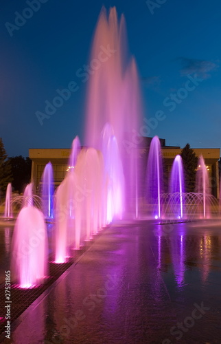 Light illumination of a city fountain at night