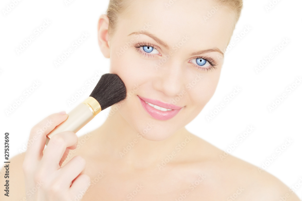 Young woman applying blusher isolated on a white background Young woman applying blusher isolated on a white background