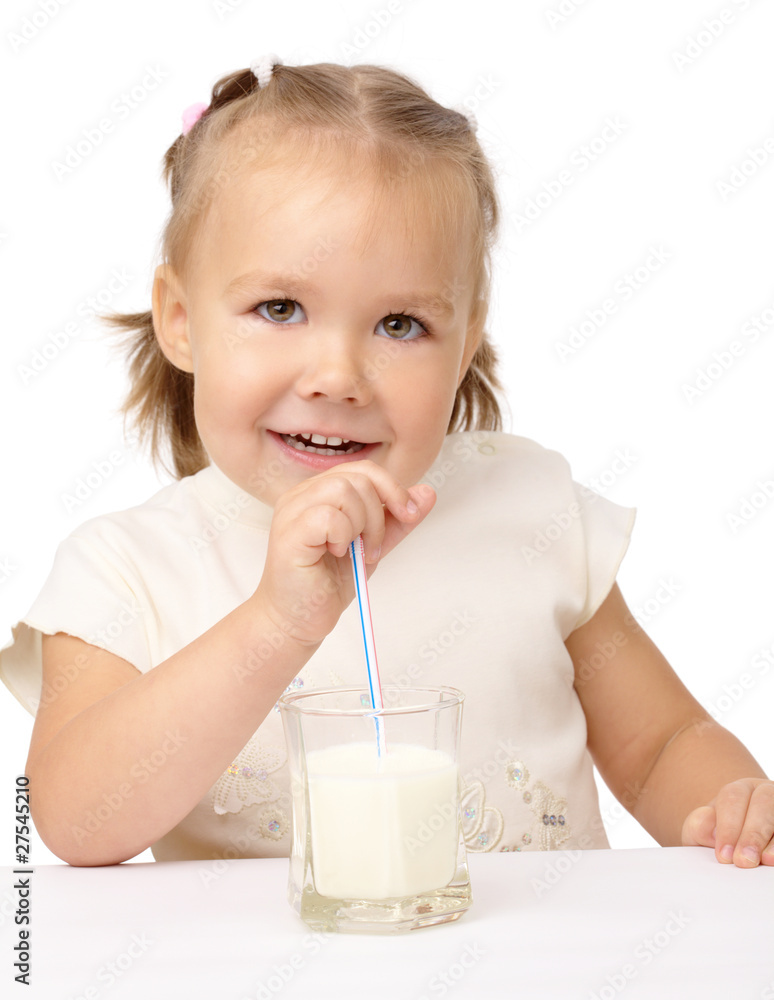 Little girl drinks milk using drinking straw Little girl drinks milk using drinking straw
