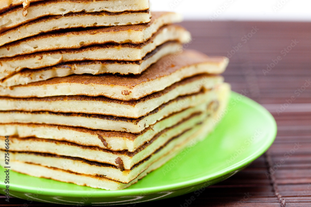 Pancakes on a plate on a bamboo mat Pancakes on a plate on a bamboo mat