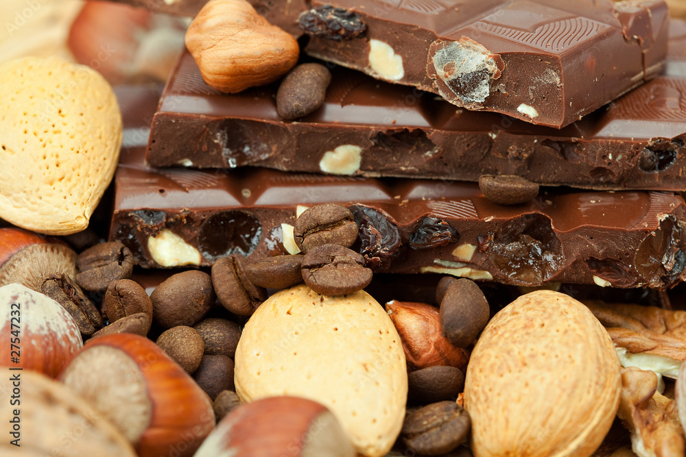 bar of chocolate and nuts on a wicker mat bar of chocolate and nuts on a wicker mat