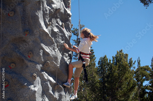 girl climbing wall