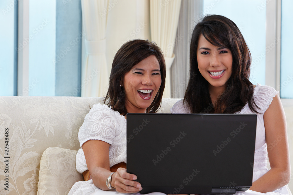 Mother and daughter using laptop Mother and daughter using laptop