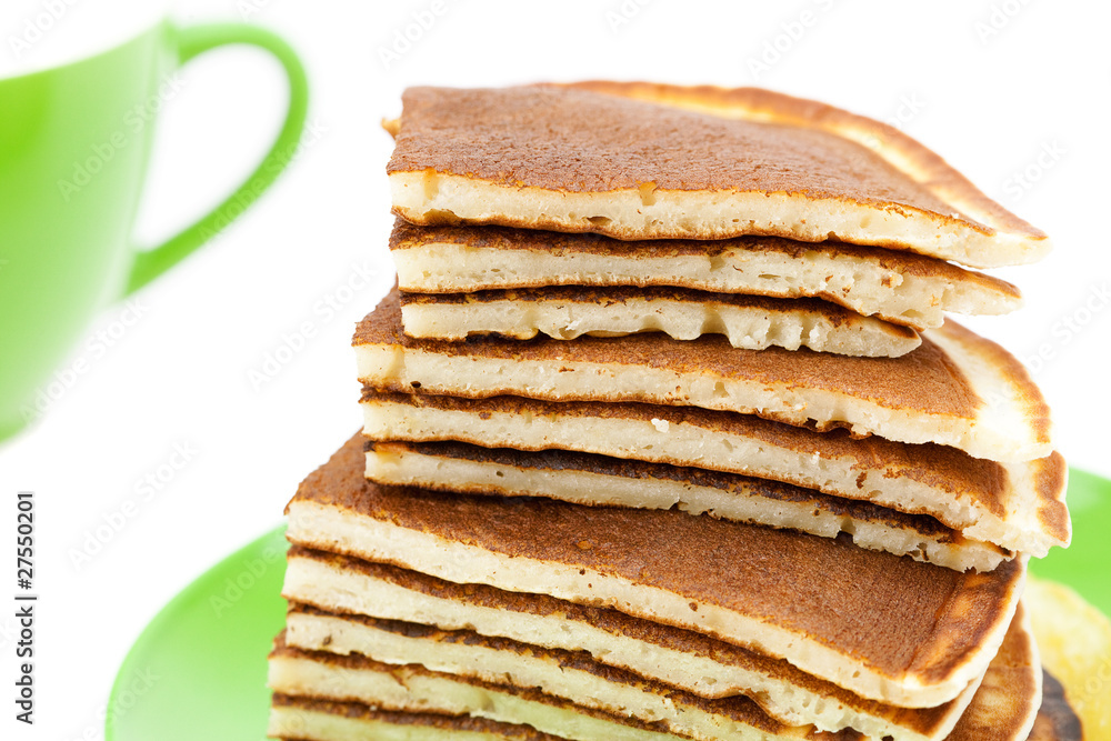 Pancakes on a plate and cup isolated on white Pancakes on a plate and cup isolated on white