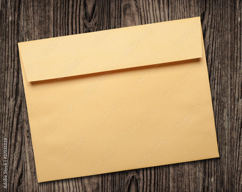 Golden envelope on wooden table. Golden envelope on wooden table.