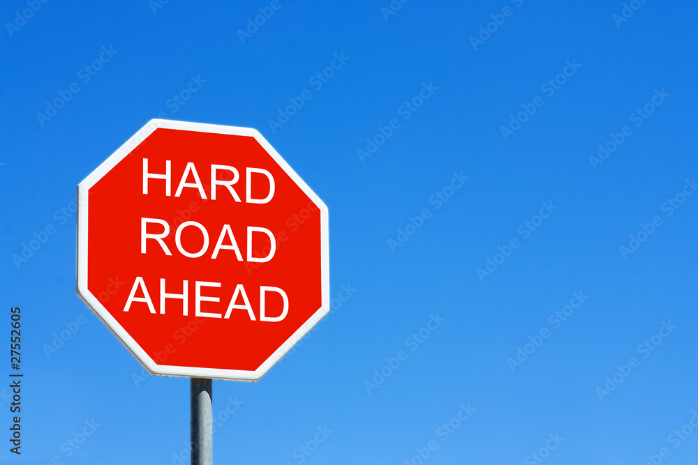 Hard Road Ahead road sign against a clear blue sky Hard Road Ahead road sign against a clear blue sky