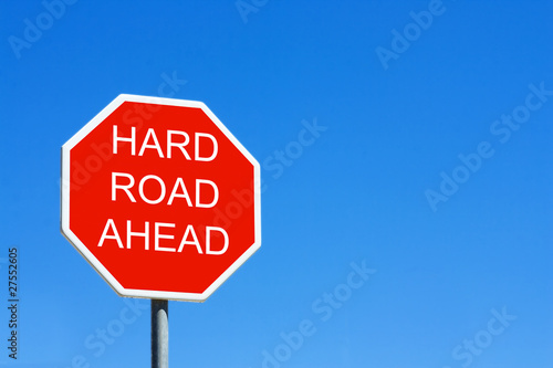 Obraz na plátně Hard Road Ahead road sign against a clear blue sky