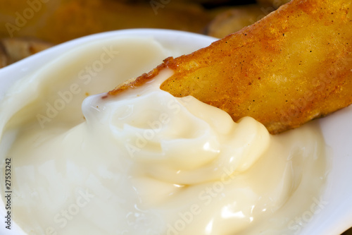 Close Up Fried Potato Dipped in Garlic Mayonnaise