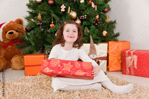 Little girl opening Christmas-boxes