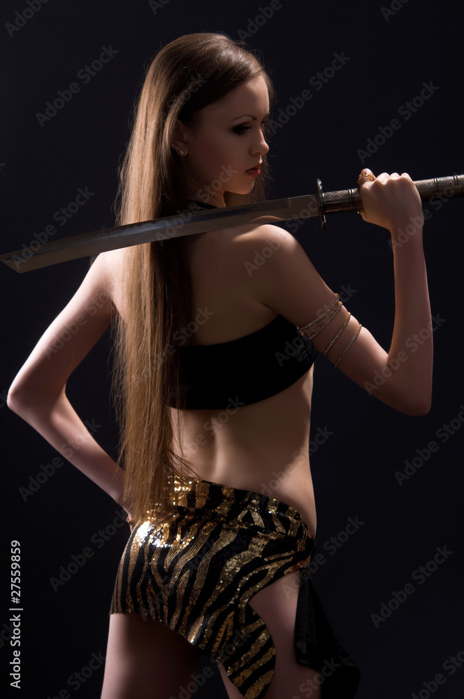 beautiful woman with a sword in the studio