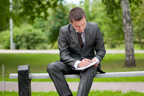 business man working with papers at park. Student © mr.markin