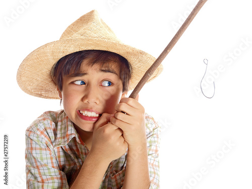 boy pulling his fishing rod arduously photo
