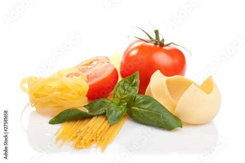 Pasta, tomato and basil leaves on white background