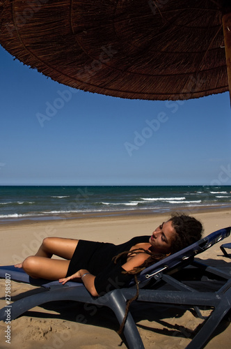 Girl in black dress resting on the beach © Foto.Priganica
