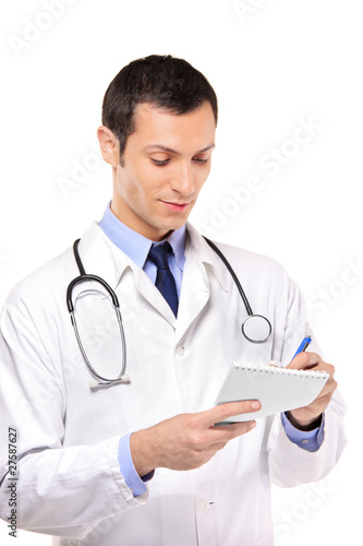 View of a young medical doctor writing down