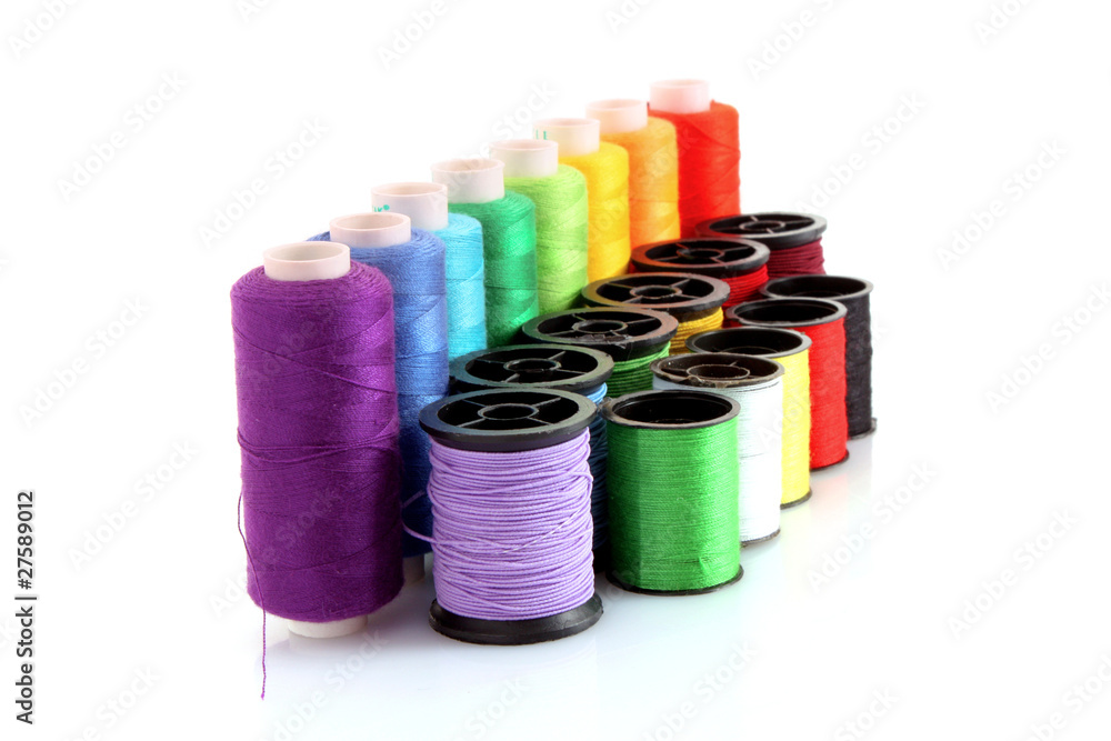 Coloured bobbins of thread isolated on white Coloured bobbins of thread isolated on white