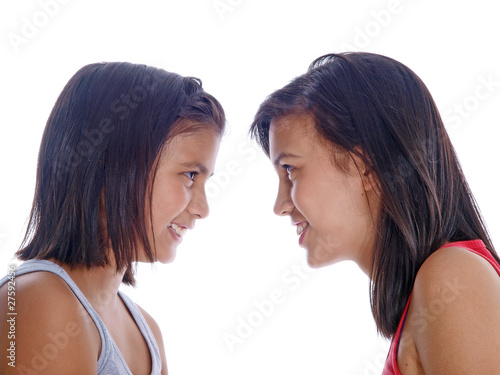 two happy teenage girls looking at each other