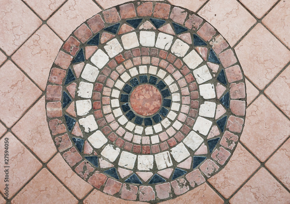 Round stone mosaic in Italian pavement / sidewalk