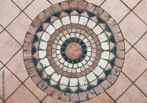 Round stone mosaic in Italian pavement / sidewalk