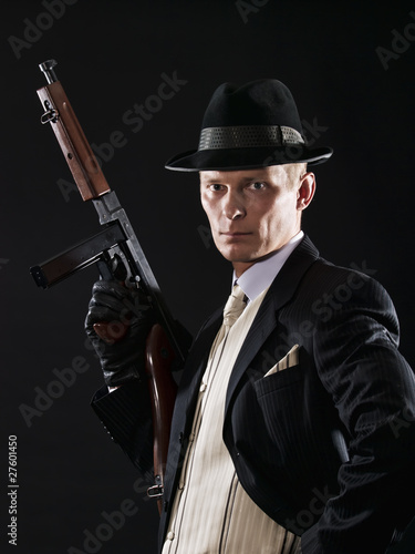 Man like a chicago gangster in suit with Thompson submachine gun photo