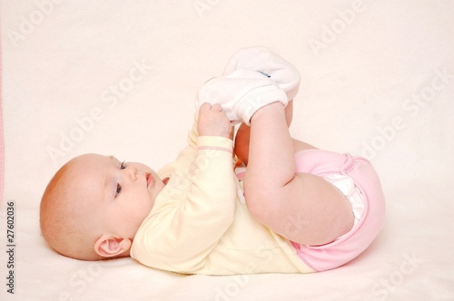 cute baby is playing with feet photo