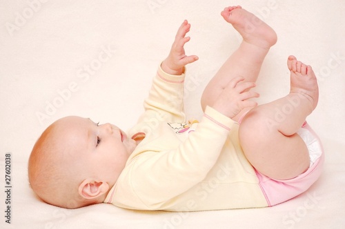 Cute baby playing with feet photo