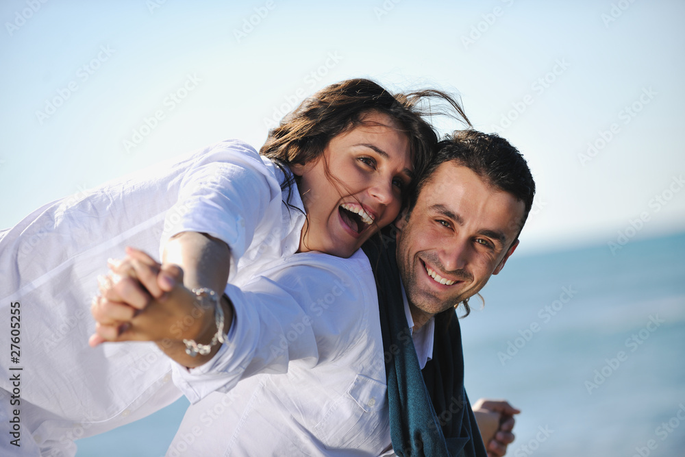 happy young couple have fun at beautiful beach happy young couple have fun at beautiful beach