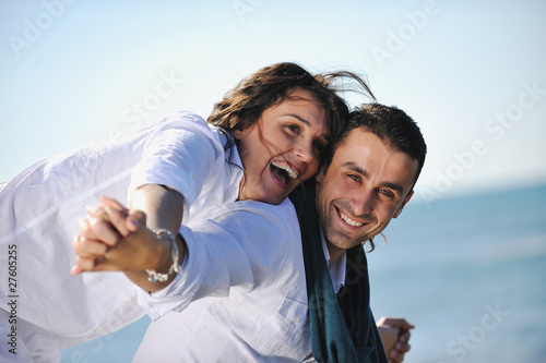 happy young couple have fun at beautiful beach