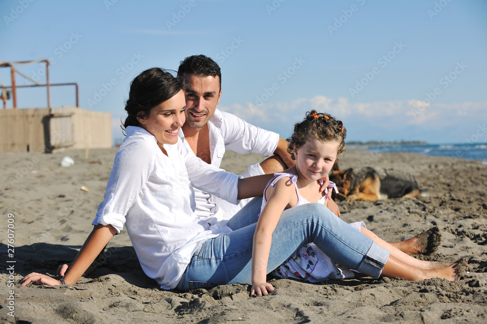 happy family playing with dog on beach happy family playing with dog on beach