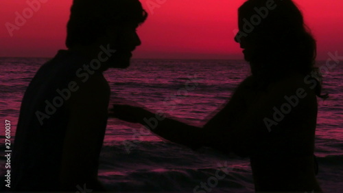 Romantic couple kisses on beach at sunset - HD