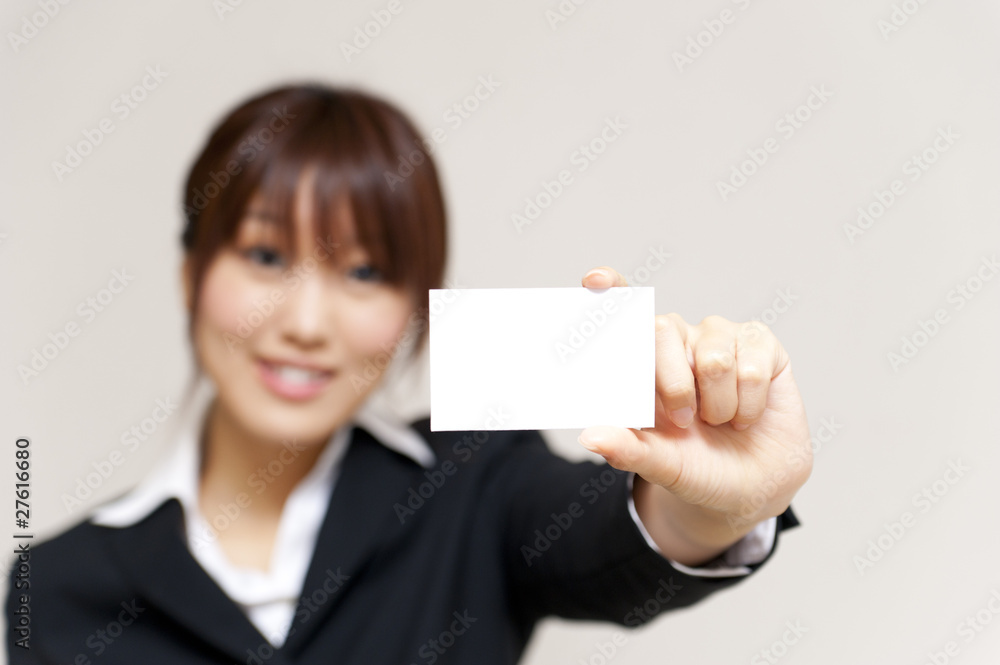 a portrait of young business woman taking a white card a portrait of young business woman taking a white card
