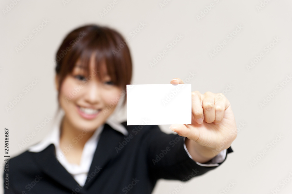 a portrait of young business woman taking a white card a portrait of young business woman taking a white card