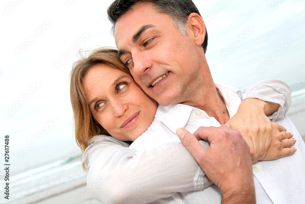 Couple embracing each other at the beach Couple embracing each other at the beach