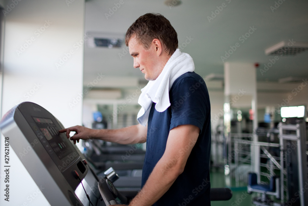 Healthy man a treadmill in a sport center