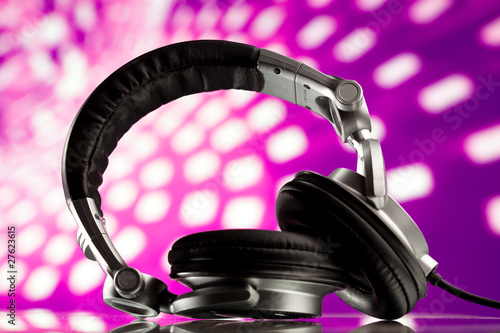 dj headphones against purple disco background photo