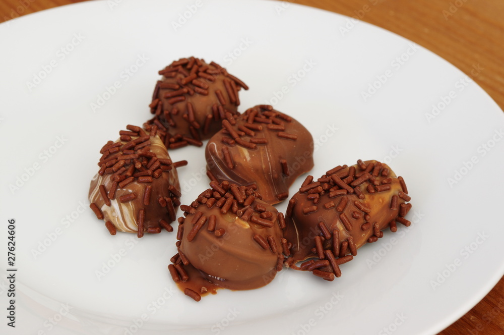 Luscious chocolate pralines on a plate. Luscious chocolate pralines on a plate.