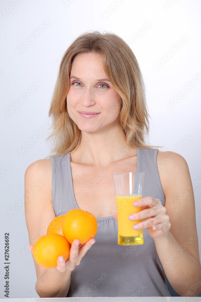 Woman drinking fresh orange juice Woman drinking fresh orange juice