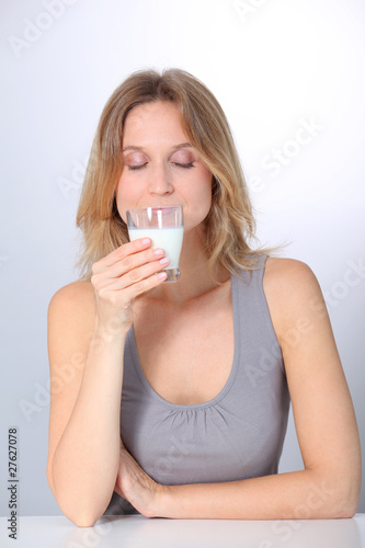 Closeup of beautiful woman drinking milk