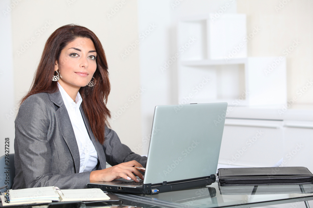 Closeup of smiling real estate agent in office Closeup of smiling real estate agent in office